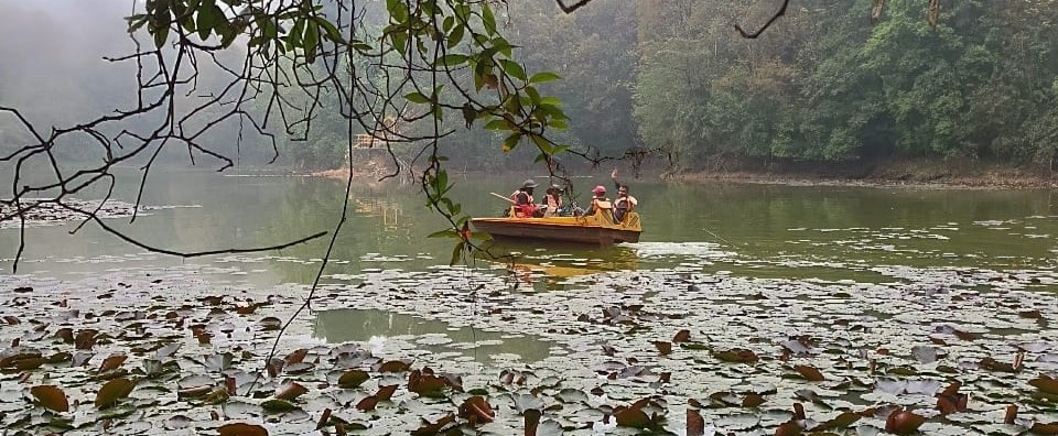 Binit Timalsina conducting a bathymetric survey by boat on a misty Himalayan lake